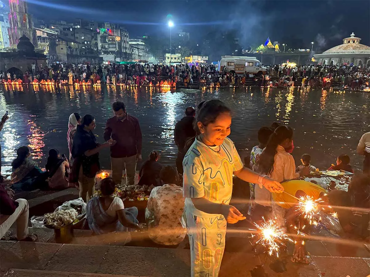 Children enjoy lighting firecrakers on Dev Diwali at Ramkund Nashik Maharashtra