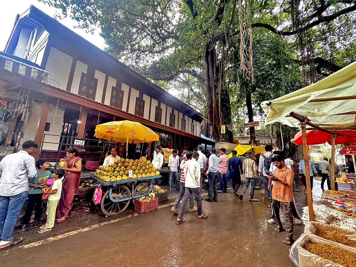 Vendors selling dry fruits, sweets, coconuts outside Sita Gufa Temple Nashik July 2026