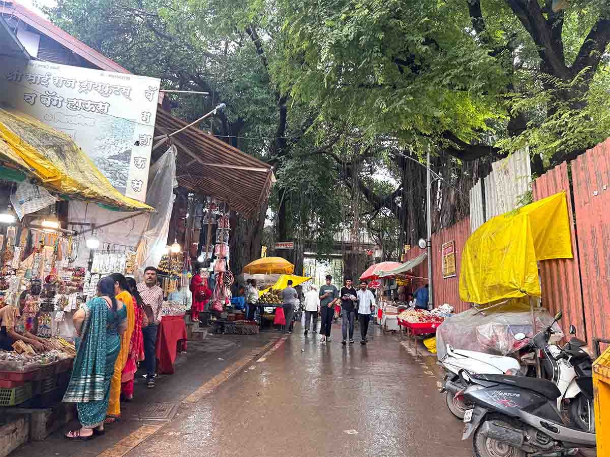 Vendors selling women's accessories, children's toys outside Sita Gufa temple